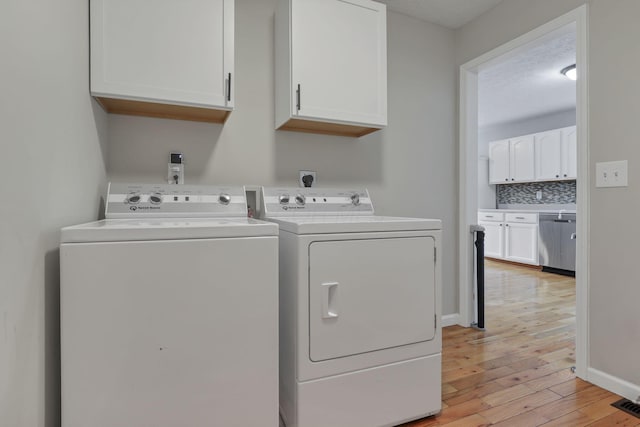 5010 Nelson Dr, South Bloomfield, OH 43103 - laundry room with cabinet space, washer and dryer, light wood-style flooring, and baseboards