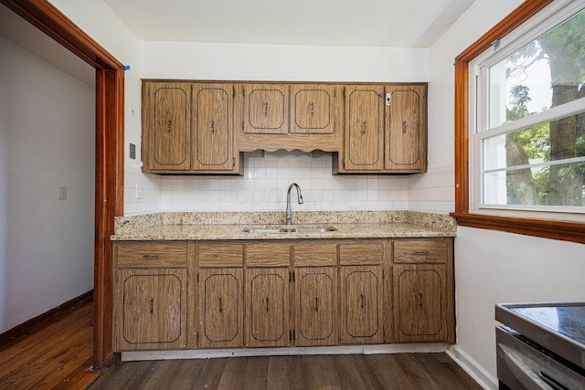 1900 S Champion Ave, Columbus, OH 43207 - kitchen featuring tasteful backsplash, dark wood-style flooring, and brown cabinetry