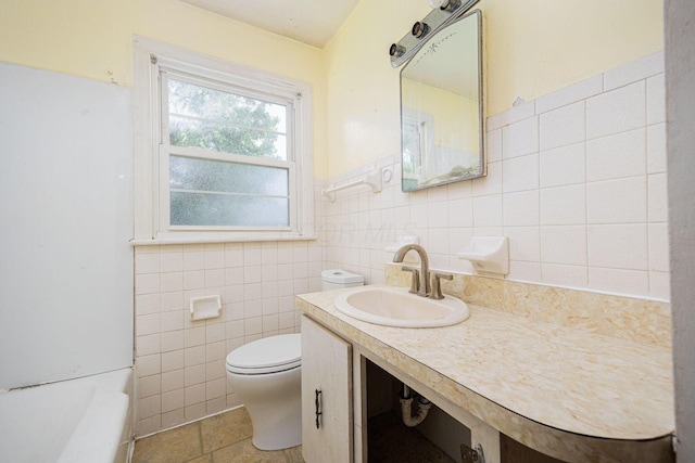 1900 S Champion Ave, Columbus, OH 43207 - full bathroom with tile walls, a bath, vanity, and a wainscoted wall