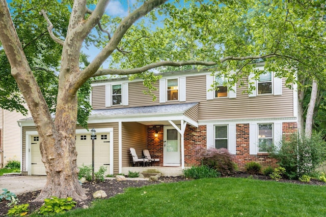 8800 Greenburg Dr, Powell, OH 43065 - view of front facade featuring brick siding, a front lawn, and a porch