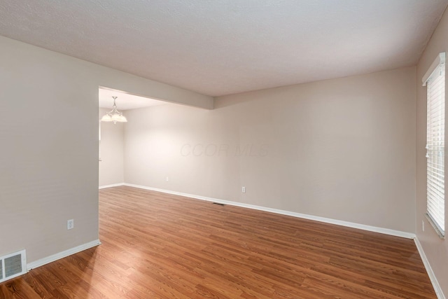 8800 Greenburg Dr, Powell, OH 43065 - unfurnished room with light wood-style flooring, baseboards, and a chandelier