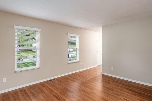 8800 Greenburg Dr, Powell, OH 43065 - spare room featuring wood finished floors, plenty of natural light, and baseboards