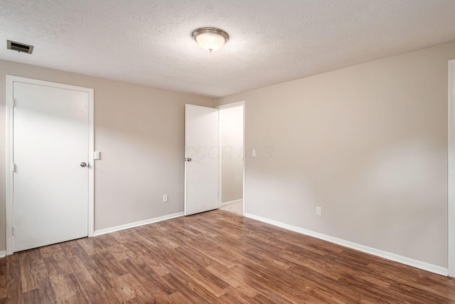8800 Greenburg Dr, Powell, OH 43065 - unfurnished bedroom featuring wood finished floors, baseboards, and a textured ceiling
