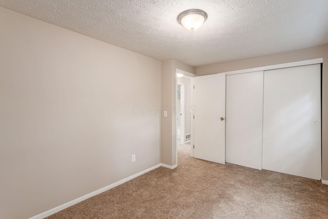 8800 Greenburg Dr, Powell, OH 43065 - unfurnished bedroom featuring light colored carpet, a textured ceiling, a closet, and baseboards