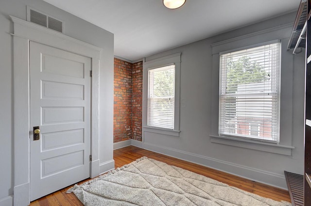 193 E Mithoff St Unit 193, Columbus, OH 43206 - foyer featuring wood finished floors and brick wall