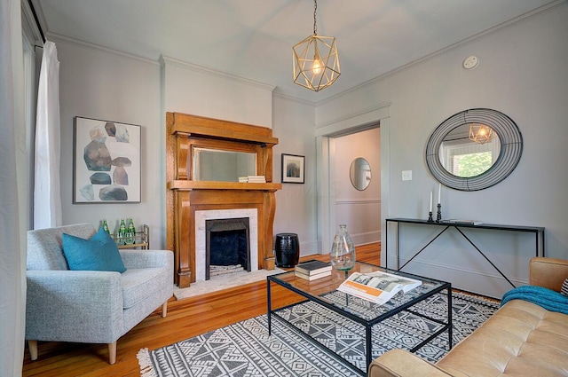 193 E Mithoff St Unit 193, Columbus, OH 43206 - living room featuring wood finished floors, ornamental molding, a fireplace with flush hearth, and a chandelier