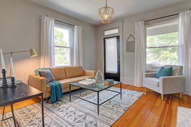 193 E Mithoff St Unit 193, Columbus, OH 43206 - living room with light wood-type flooring, crown molding, and a chandelier
