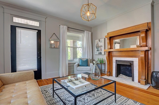 193 E Mithoff St Unit 193, Columbus, OH 43206 - living room featuring wood finished floors, crown molding, a fireplace with flush hearth, and a chandelier