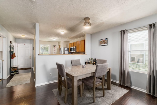 7524 Hemrich Dr, Canal Winchester, OH 43110 - dining area featuring dark wood-style flooring and a textured ceiling