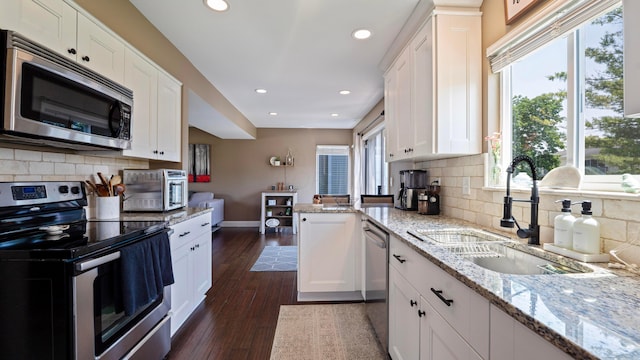 5225 Springdale Blvd, Hilliard, OH 43026 - kitchen featuring stainless steel appliances, white cabinetry, recessed lighting, tasteful backsplash, and dark wood finished floors