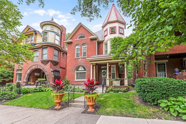 1167 Neil Ave, Columbus, OH 43201 - victorian home with brick siding, covered porch, and a front yard