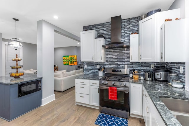 1167 Neil Ave, Columbus, OH 43201 - kitchen with wall chimney range hood, stainless steel gas range, black microwave, white cabinets, and recessed lighting