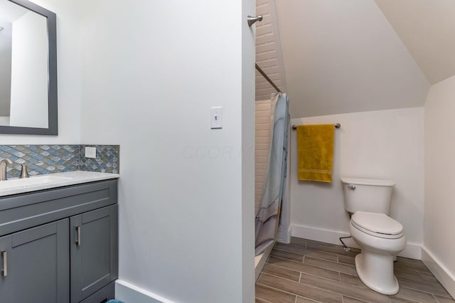 1167 Neil Ave, Columbus, OH 43201 - bathroom featuring baseboards, vanity, toilet, wood finished floors, and a shower with curtain