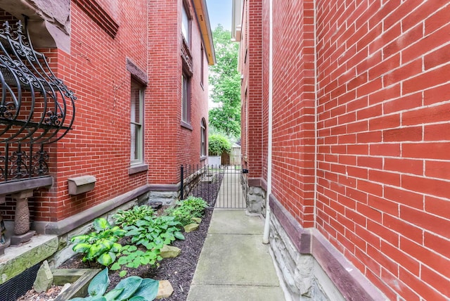 1167 Neil Ave, Columbus, OH 43201 - view of side of home featuring brick siding and a gate