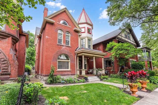 1167 Neil Ave, Columbus, OH 43201 - view of front of house with brick siding, a front lawn, a chimney, and a porch