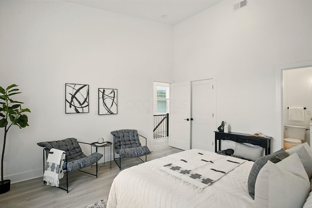 92 E Innis Ave, Columbus, OH 43207 - bedroom featuring light wood-style flooring, a towering ceiling, and ensuite bath