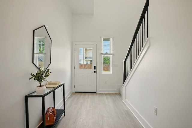 92 E Innis Ave, Columbus, OH 43207 - entryway featuring plenty of natural light, stairway, light wood-type flooring, and a towering ceiling