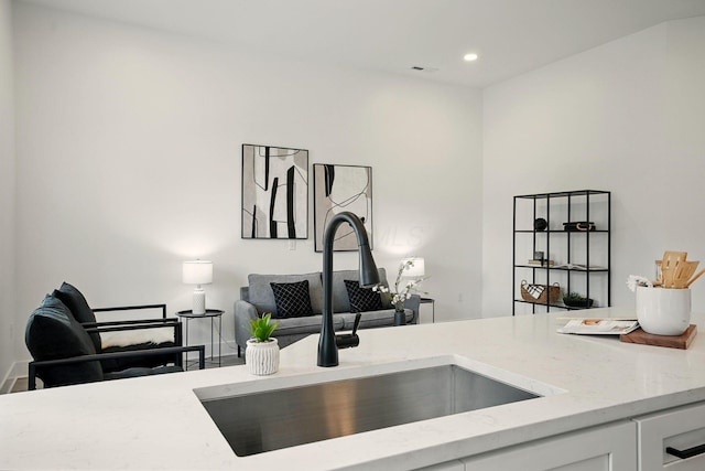 92 E Innis Ave, Columbus, OH 43207 - kitchen view of light stone counters, white cabinetry, and recessed lighting