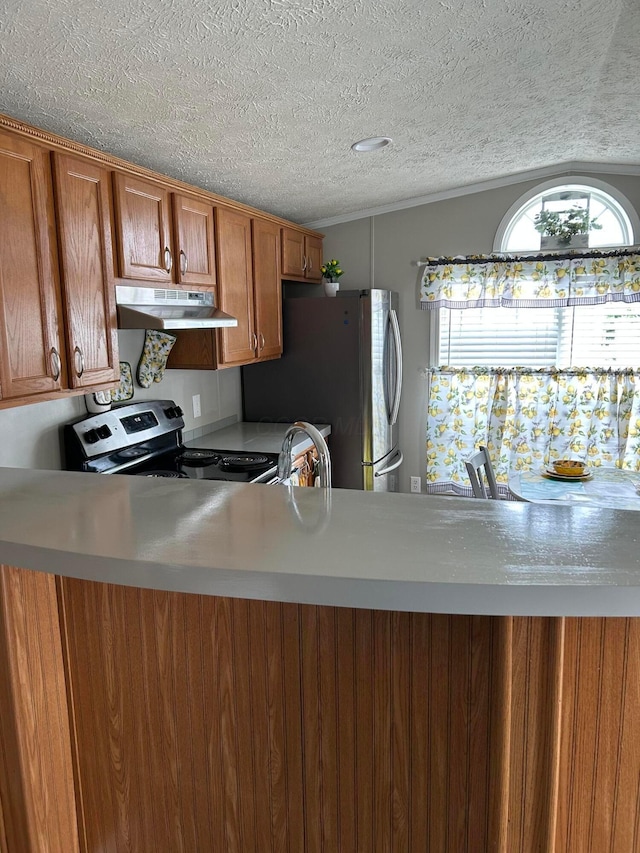 5019 N High St Unit 97, Columbus, OH 43214 - kitchen with under cabinet range hood, stainless steel appliances, brown cabinets, a textured ceiling, and light countertops