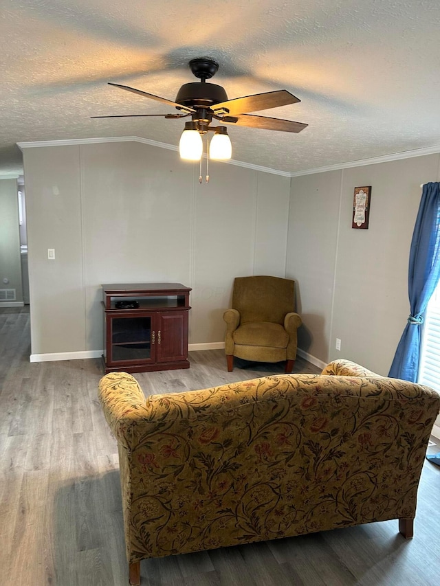 5019 N High St Unit 97, Columbus, OH 43214 - living room featuring a ceiling fan, wood finished floors, ornamental molding, a textured ceiling, and baseboards