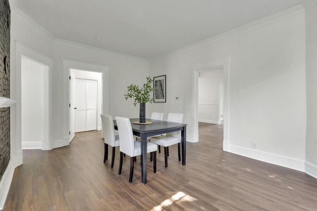 638 E 6th Ave, Lancaster, OH 43130 - dining area featuring wood finished floors, crown molding, and a brick fireplace