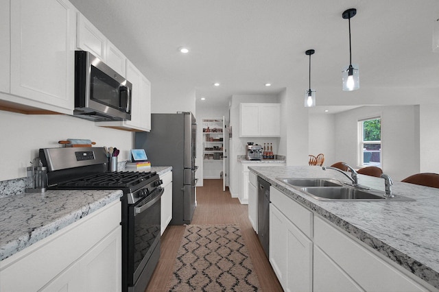 120 Heron Ave, Pataskala, OH 43062 - kitchen featuring stainless steel appliances, dark wood-type flooring, white cabinets, decorative light fixtures, and recessed lighting