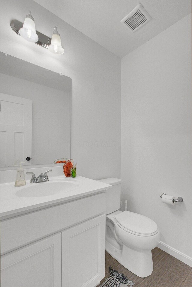 120 Heron Ave, Pataskala, OH 43062 - half bathroom with vanity and wood finished floors