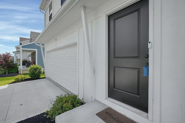 120 Heron Ave, Pataskala, OH 43062 - view of exterior entry with a garage and concrete driveway