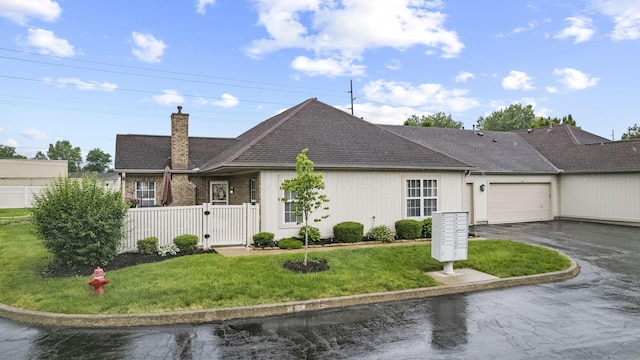 305 Pointe Pl Unit 12, Westerville, OH 43082 - view of front facade featuring a chimney, asphalt driveway, a gate, an attached garage, and roof with shingles