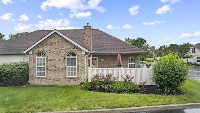 305 Pointe Pl Unit 12, Westerville, OH 43082 - rear view of house featuring brick siding, a chimney, a lawn, and roof with shingles