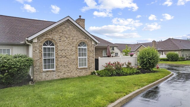 305 Pointe Pl Unit 12, Westerville, OH 43082 - view of property exterior featuring a chimney, brick siding, and roof with shingles