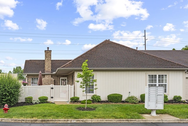 305 Pointe Pl Unit 12, Westerville, OH 43082 - view of front facade with a chimney, a shingled roof, and a gate