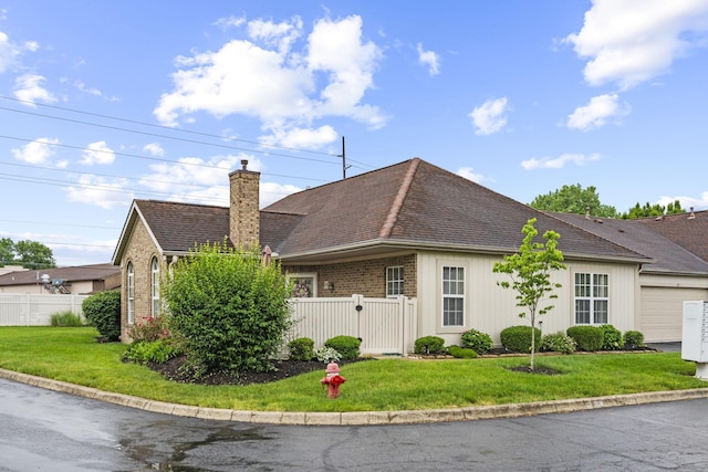 305 Pointe Pl Unit 12, Westerville, OH 43082 - view of side of property featuring a chimney, a garage, brick siding, and roof with shingles