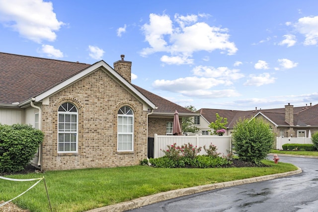 305 Pointe Pl Unit 12, Westerville, OH 43082 - view of home's exterior with a chimney, brick siding, and roof with shingles