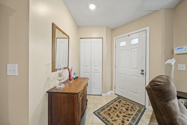 305 Pointe Pl Unit 12, Westerville, OH 43082 - entryway featuring light tile patterned flooring, baseboards, and a textured ceiling