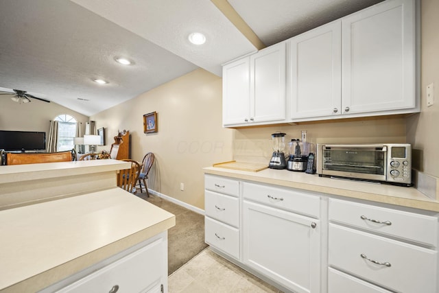305 Pointe Pl Unit 12, Westerville, OH 43082 - kitchen with a textured ceiling, lofted ceiling, light countertops, white cabinets, and recessed lighting