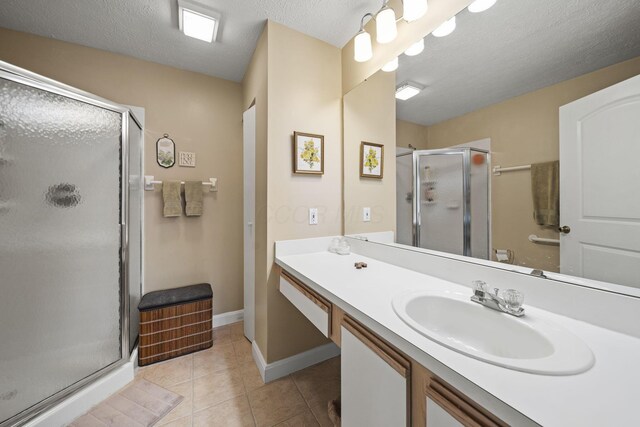 305 Pointe Pl Unit 12, Westerville, OH 43082 - bathroom with vanity, a stall shower, tile patterned flooring, a textured ceiling, and baseboards