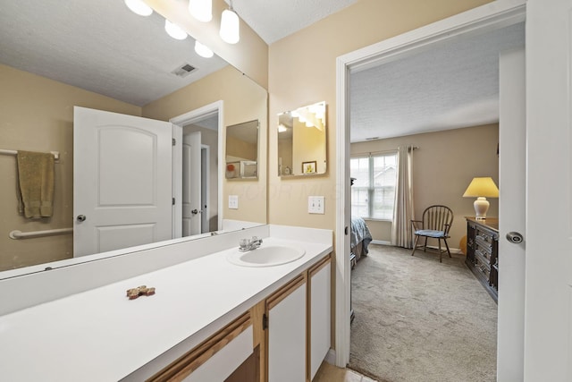 305 Pointe Pl Unit 12, Westerville, OH 43082 - ensuite bathroom with a textured ceiling, vanity, and baseboards