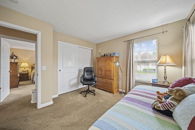 305 Pointe Pl Unit 12, Westerville, OH 43082 - bedroom with light carpet, baseboards, a closet, and a textured ceiling