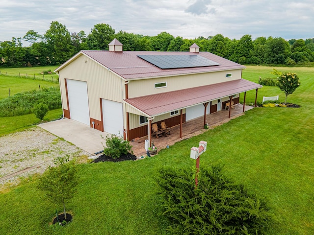 4091 Township Road 21, Marengo, OH 43334 - view of front facade featuring a front yard, gravel driveway, a detached garage, metal roof, and an outbuilding