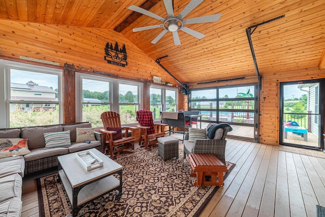 4091 Township Road 21, Marengo, OH 43334 - living area featuring wood ceiling with exposed beams, wooden walls, healthy amount of natural light, a ceiling fan, and hardwood / wood-style flooring
