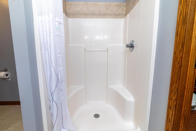 4091 Township Road 21, Marengo, OH 43334 - bathroom featuring a shower with shower curtain, tile patterned flooring, and baseboards