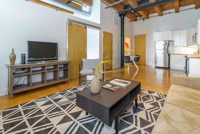150 E Main St Unit 405, Columbus, OH 43215 - living room with a towering ceiling and light wood-style floors