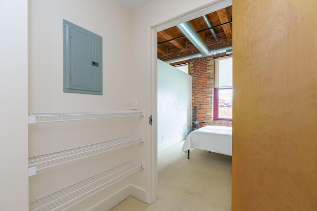 150 E Main St Unit 405, Columbus, OH 43215 - bedroom featuring electric panel, carpet flooring, and brick wall