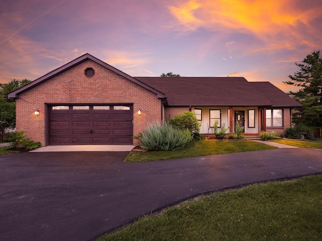8120 Morgan Rd, West Jefferson, OH 43162 - view of front of home with driveway, brick siding, a garage, and a front lawn