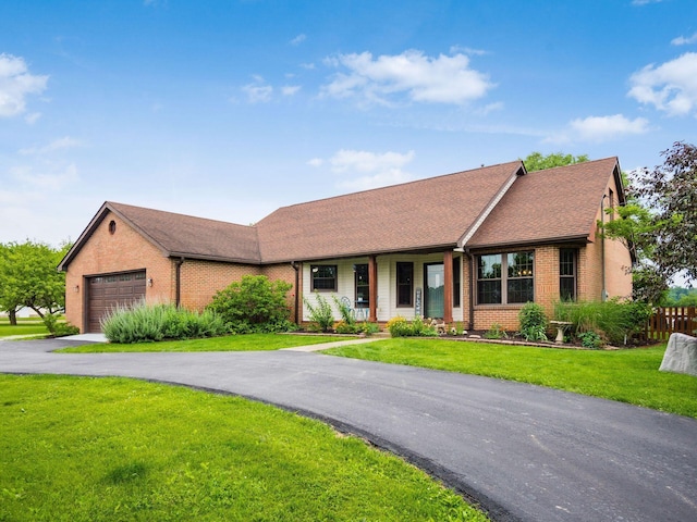 8120 Morgan Rd, West Jefferson, OH 43162 - ranch-style house featuring brick siding, a garage, driveway, roof with shingles, and covered porch