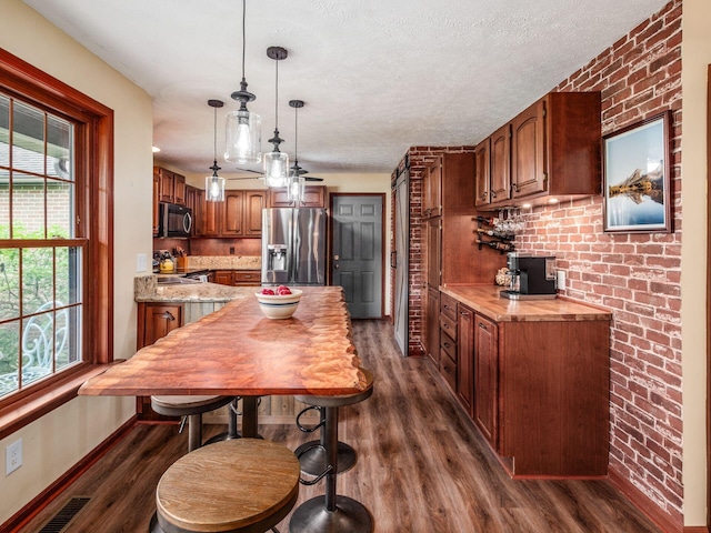 8120 Morgan Rd, West Jefferson, OH 43162 - kitchen with appliances with stainless steel finishes, dark wood-type flooring, healthy amount of natural light, light countertops, and a textured ceiling