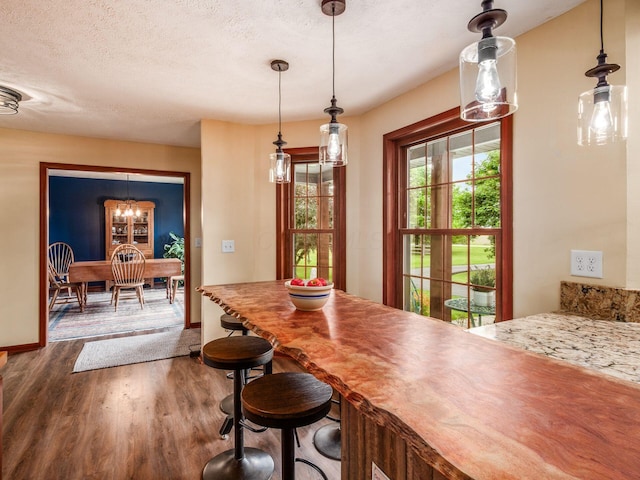 8120 Morgan Rd, West Jefferson, OH 43162 - dining area with wood finished floors, a chandelier, and a textured ceiling