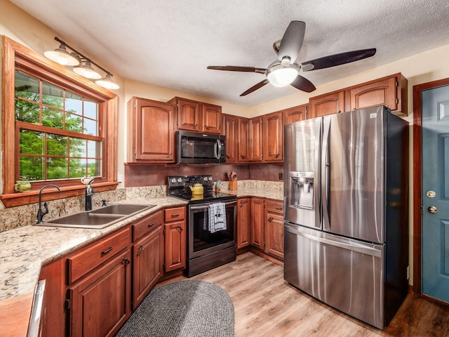 8120 Morgan Rd, West Jefferson, OH 43162 - kitchen featuring stainless steel appliances, ceiling fan, a textured ceiling, light wood-type flooring, and brown cabinets