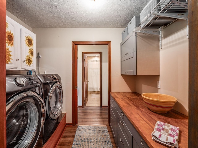 8120 Morgan Rd, West Jefferson, OH 43162 - laundry room with cabinet space, washer and clothes dryer, dark wood-style flooring, and a textured ceiling